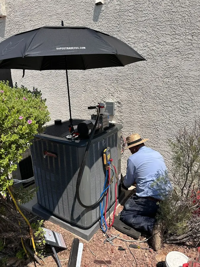 HVAC technician performing outdoor AC maintenance in Moab